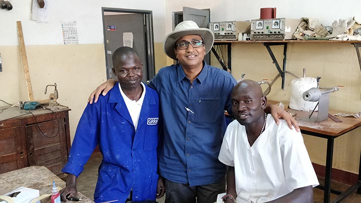Professor Mahesh Nirmalan visiting healthcare workers in Uganda.