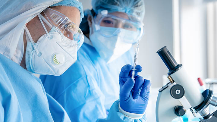 Researchers begin an experiment in a clean lab.