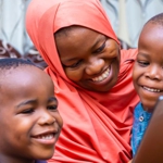 A woman with two young boys.