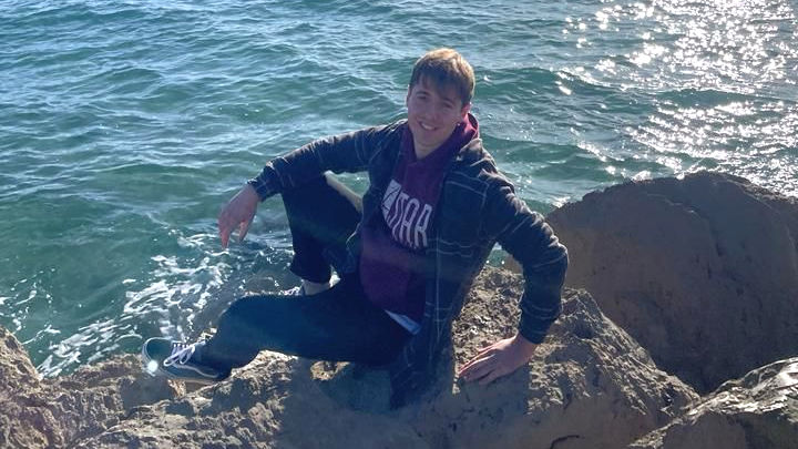A photo of Callum by the sea.