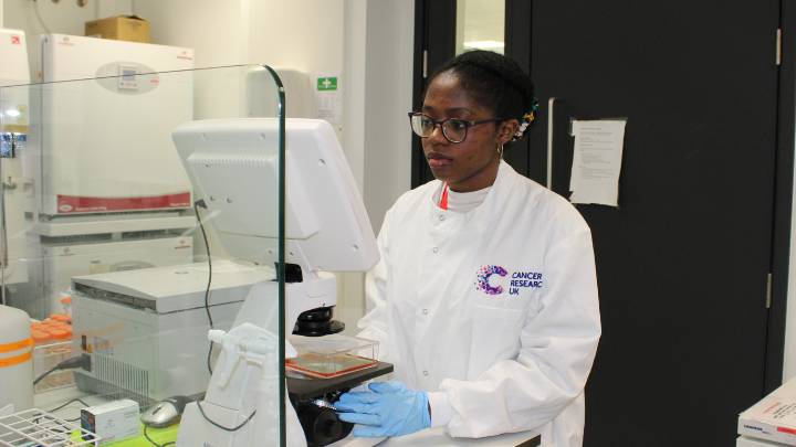 A researcher using a tablet to record observations during an experiment.