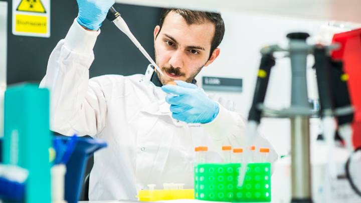 Researchers analysing a sample in the lab.