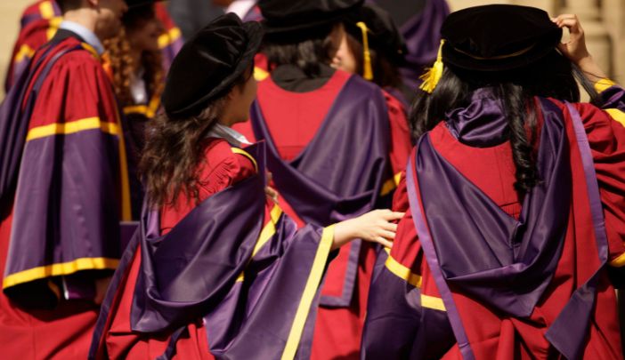 PhD students in their gowns ready to graduate