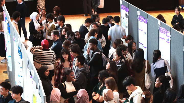 Students looking at posters.