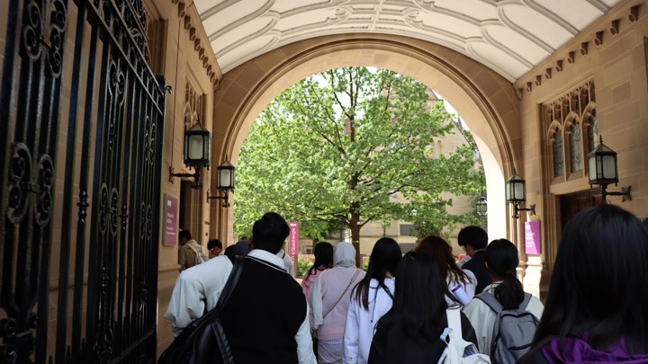 People walking through an archway.